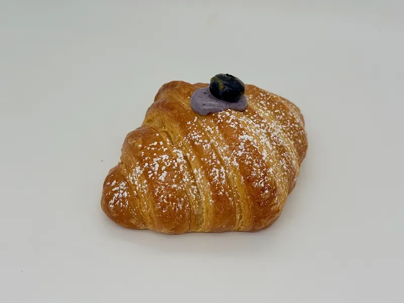 Blueberry Cream Croissant - Flaky butter croissant filled with silky blueberry cream and topped with a fresh blueberry. Light, creamy, and bursting with juicy berry flavor.