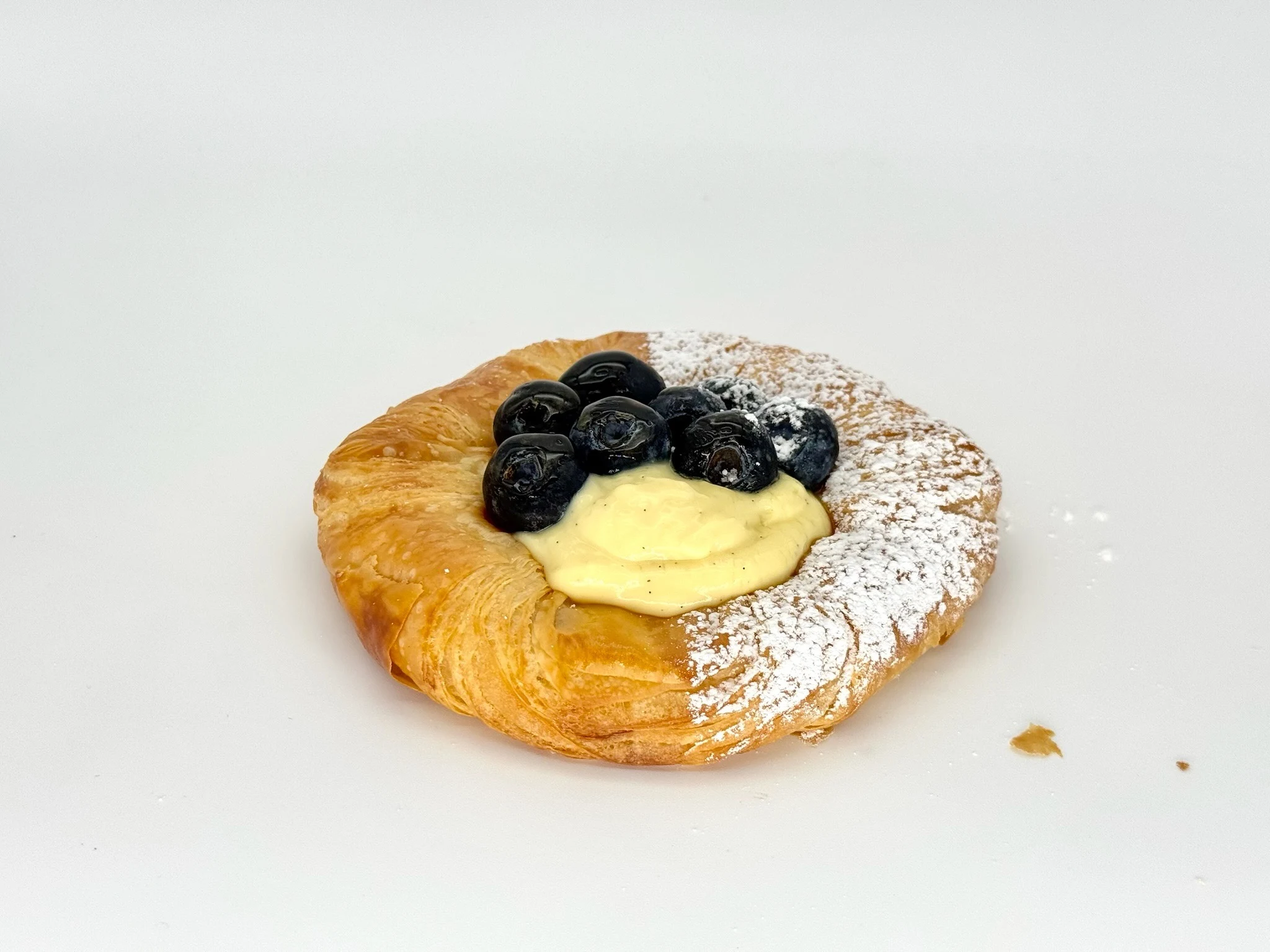Crème Danish with Fresh Blueberries - Golden, flaky pastry topped with silky vanilla crème piped fresh after baking and crowned with juicy blueberries. Cool, creamy, and irresistibly fresh.