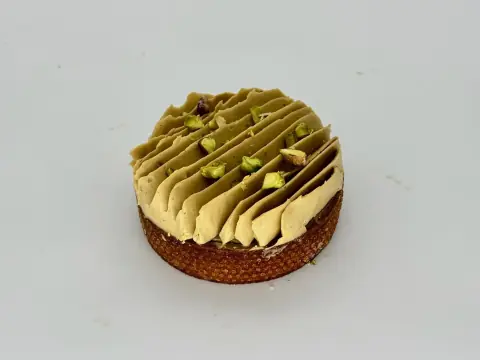 Pistachio Delight Tartlet - A true pistachio lover's dream. Crisp almond sable layered with rich pistachio frangipane, silky vanilla ganache, and finished with airy whipped pistachio ganache cream. Nutty, creamy, and luxuriously smooth with deep pistachio flavor.
