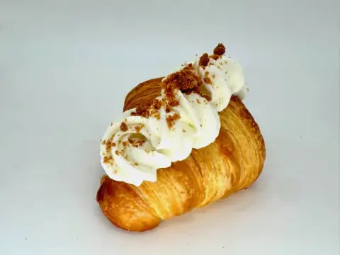 Pumpkin Latte Cream Croissant - Flaky butter croissant filled with silky custard cream made with spiced pumpkin puree and milky latte coffee, topped with whipped cream and cookie crumble.
