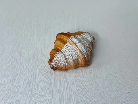 Vanilla Cream Croissant - Buttery, flaky layers filled with smooth vanilla cream that melts softly with every bite. Light, luscious, and irresistibly indulgent.